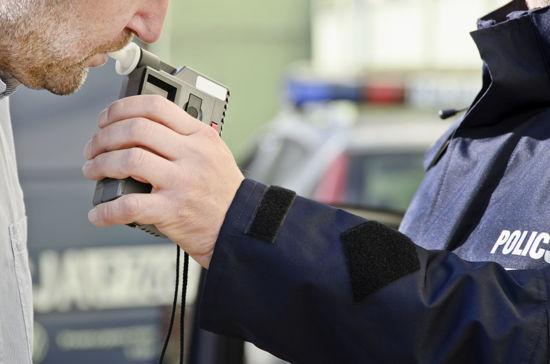 person taking a breathalyzer test