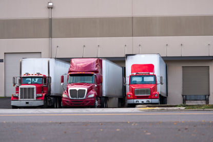 semi trucks backed up to docking bays