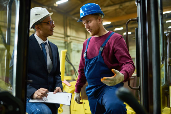 two men in hardhats talking