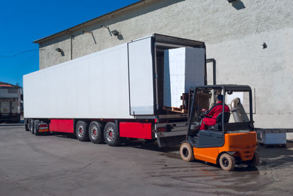 man using forklift to load semi trailer