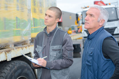 two men looking at trailer