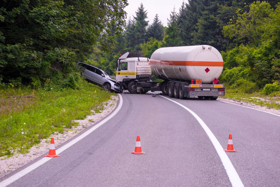 traffic cones blocking wreck between car and tanker truck