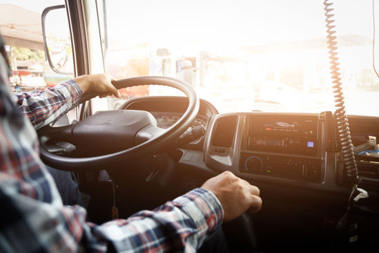 truck driver with hand on gear shift