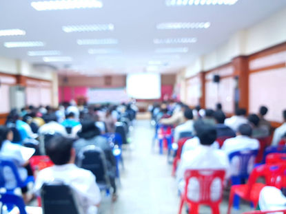 blurred group of people at a public meeting 