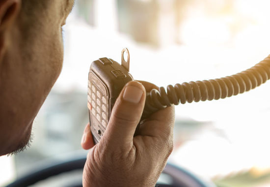 person with handheld radio