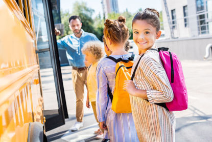 children loading a school bus