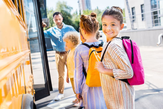 children loading a school bus