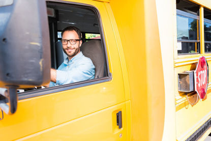 person behind the wheel of a school bus