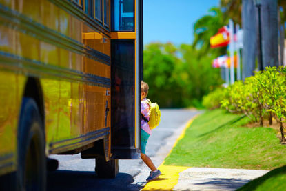 child stepping onto a bus