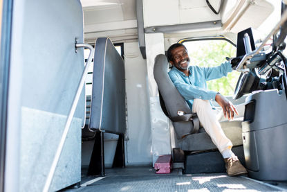 smiling person behind the wheel of a vehicle