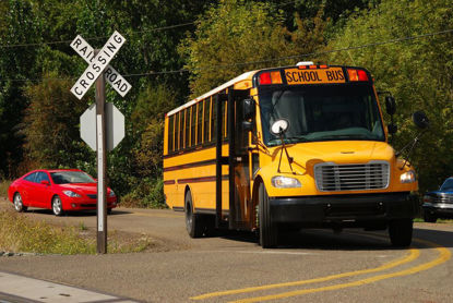  bus approaching a railroad crossing