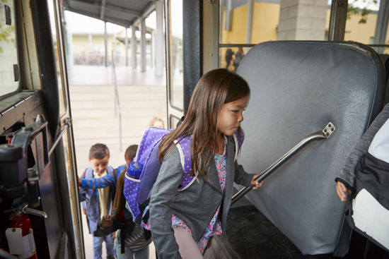 children boarding a school bus